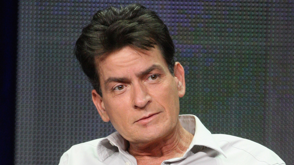 Charlie Sheen with a neutral expression during an appearance