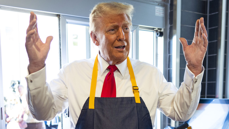 Donald Trump with both hands up while working at McDonalds