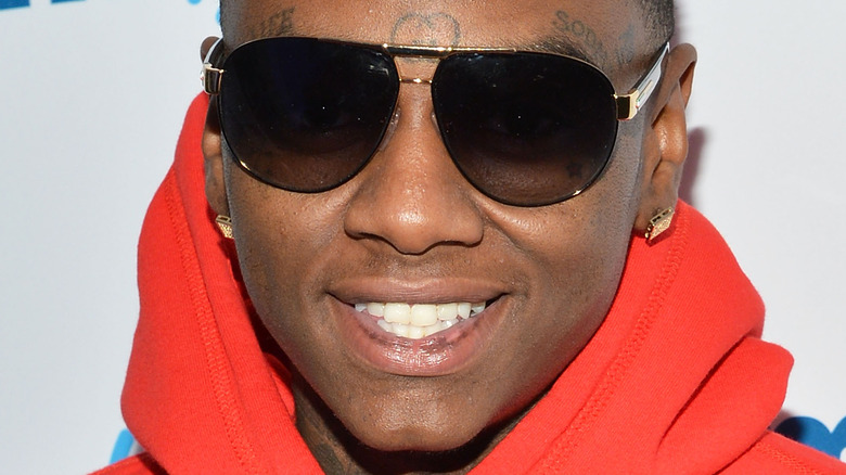 Soulja Boy wearing a red hoodie 