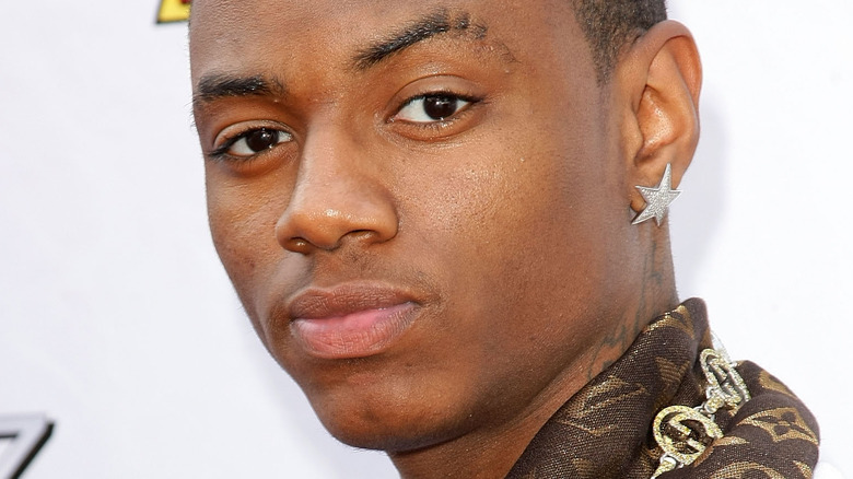 Soulja Boy wearing a a star-shaped earring