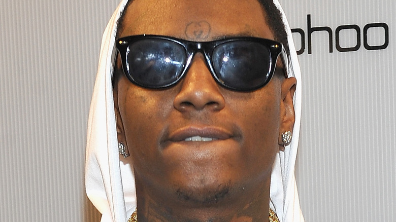 Soulja Boy wearing a white hoodie