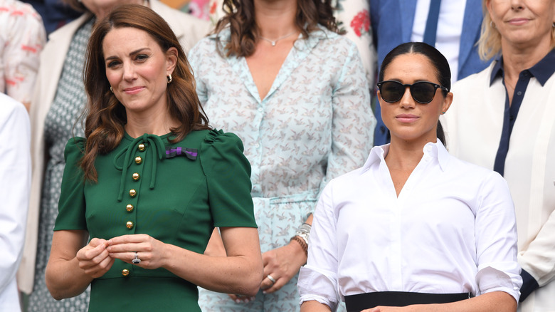 Meghan Markle and Kate Middleton standing