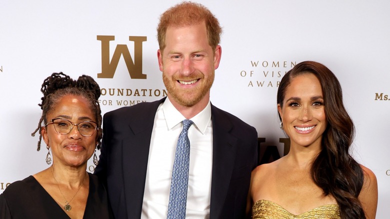 Doria Ragland, Prince Harry, and Meghan Markle smiling