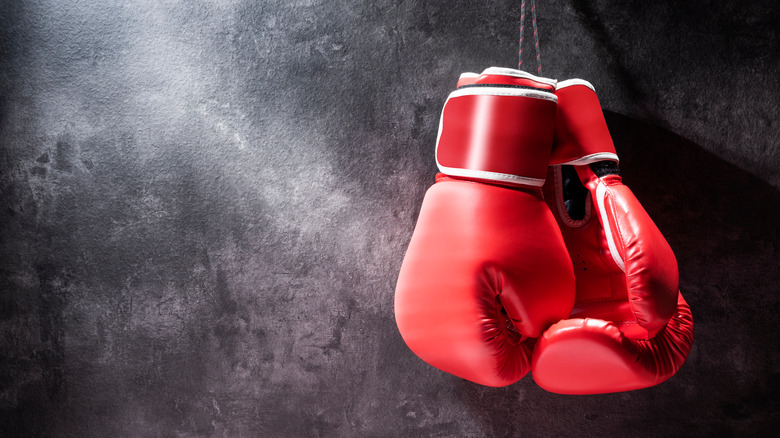 Boxing gloves hanging in front of wall