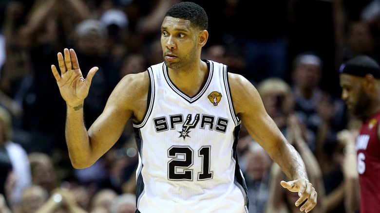 Tim Duncan playing for the Spurs, Lebron James in the background