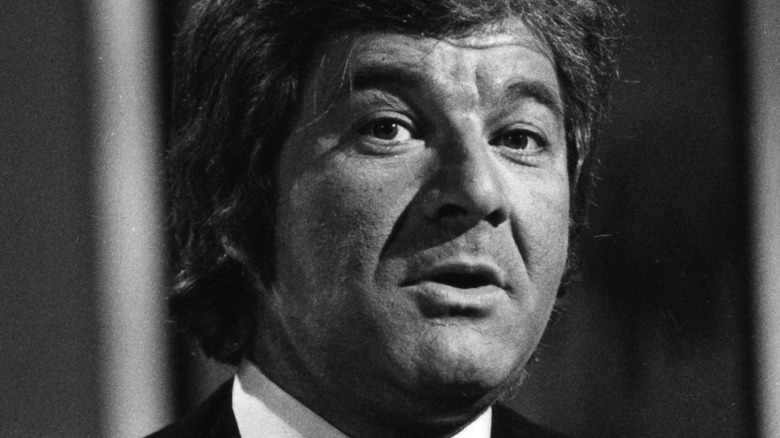 Dick Shawn wearing a suit in black and white photo