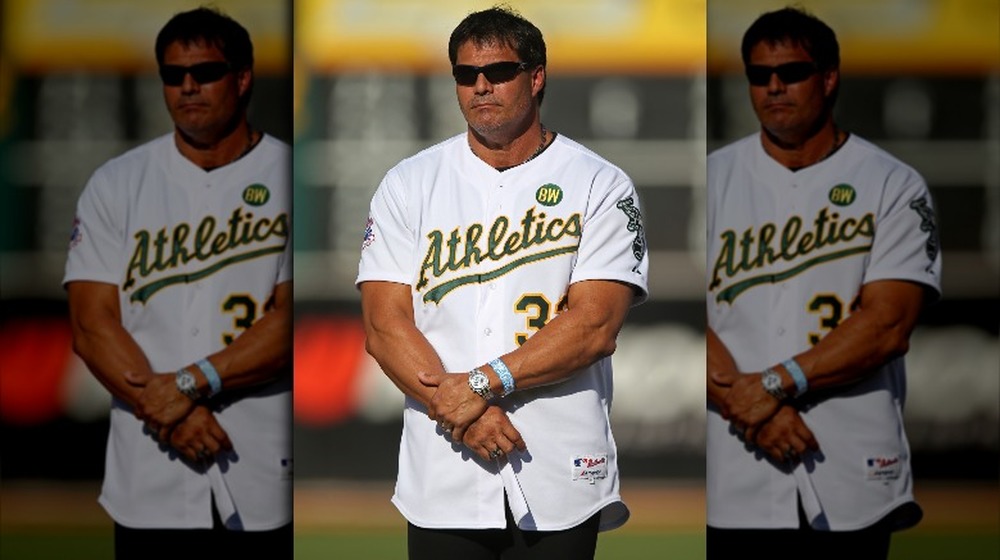 Jose Canseco poses on the pitch in 2014