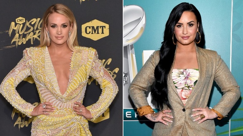 Carrie Underwood and Demi Lovato posing with hands on hips