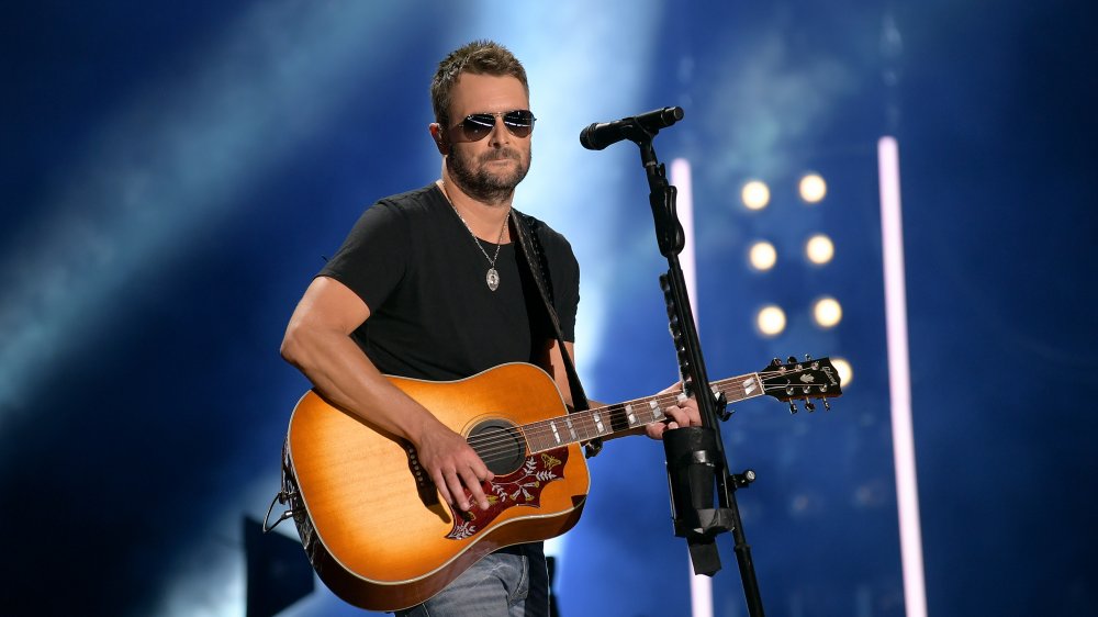 Eric Church with a guitar on stage