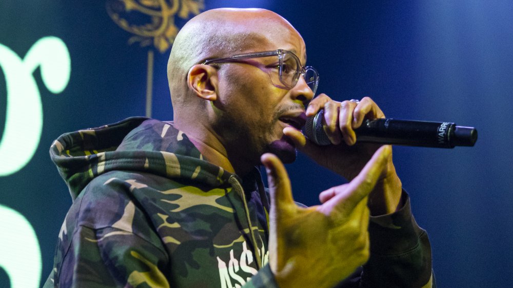 Warren G on stage, rapping, with glasses