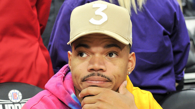 Chance The Rapper with his hand on his chin