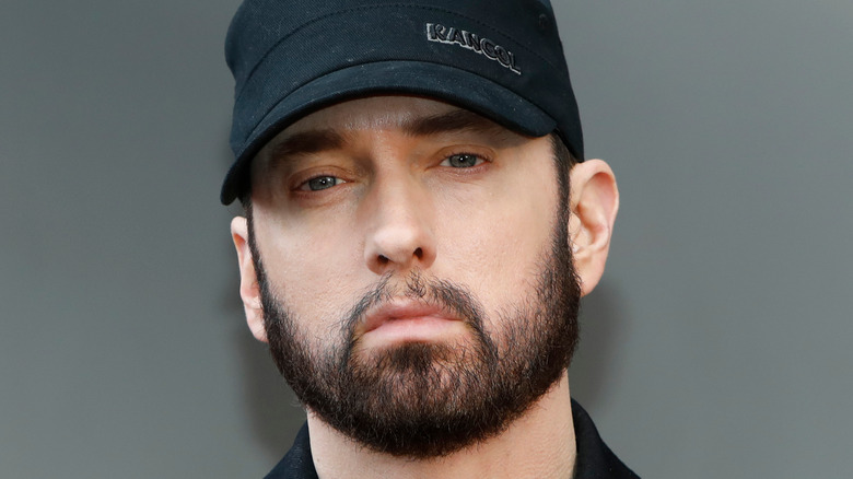 Eminem wearing a black cap