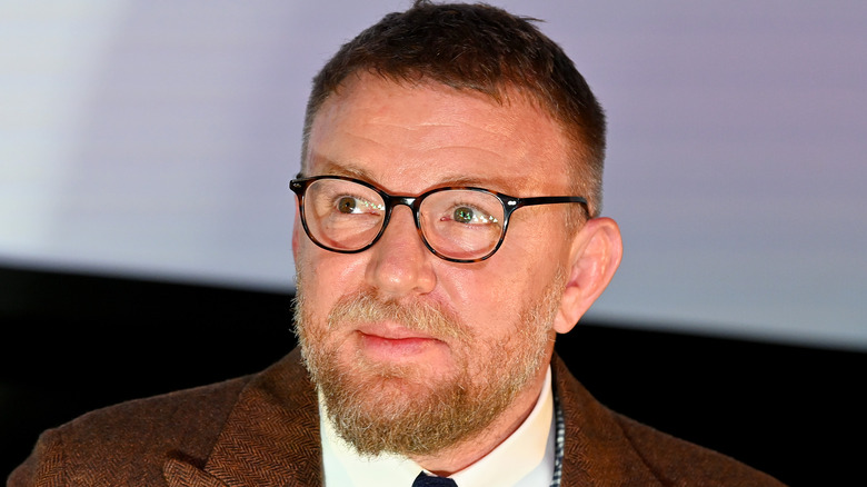 Guy Ritchie wearing glasses 