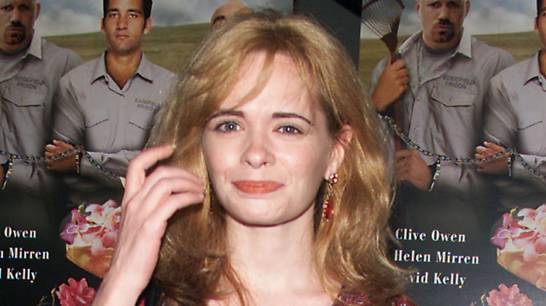 Adrienne Shelly smiling, brushing hair away from face