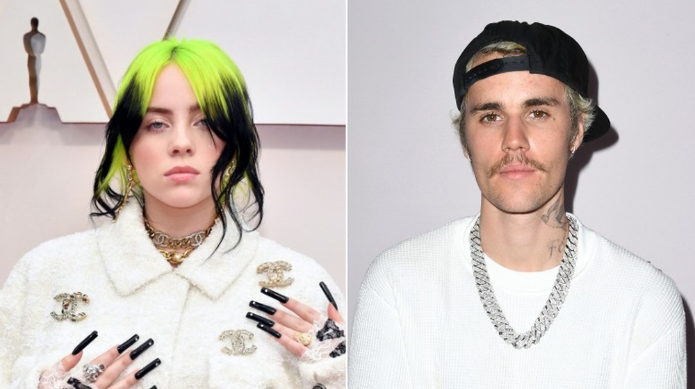 Billie Eilish with green hair and long black nails, Justin Bieber looking at camera