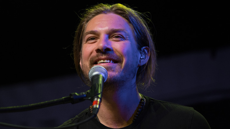 Taylor Hanson smiling into mic