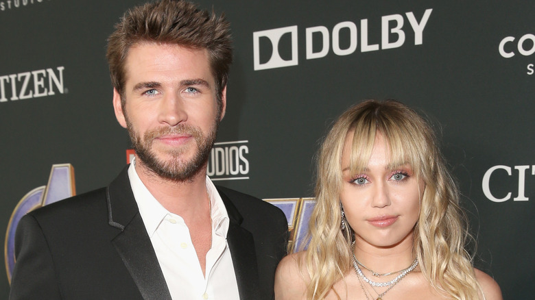 Liam Hemsworth and Miley Cyrus smile softly