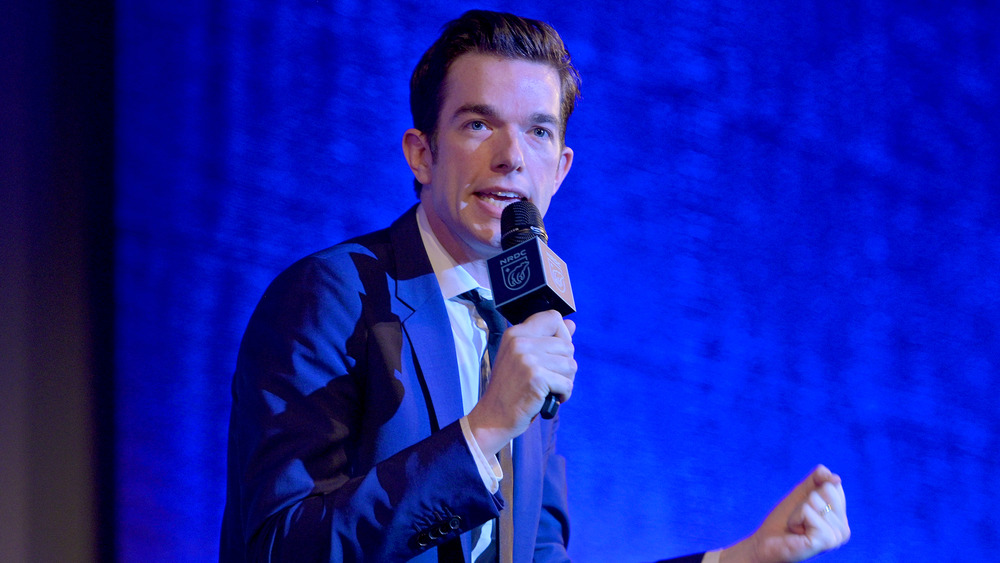 John Mulaney speaking onstage 