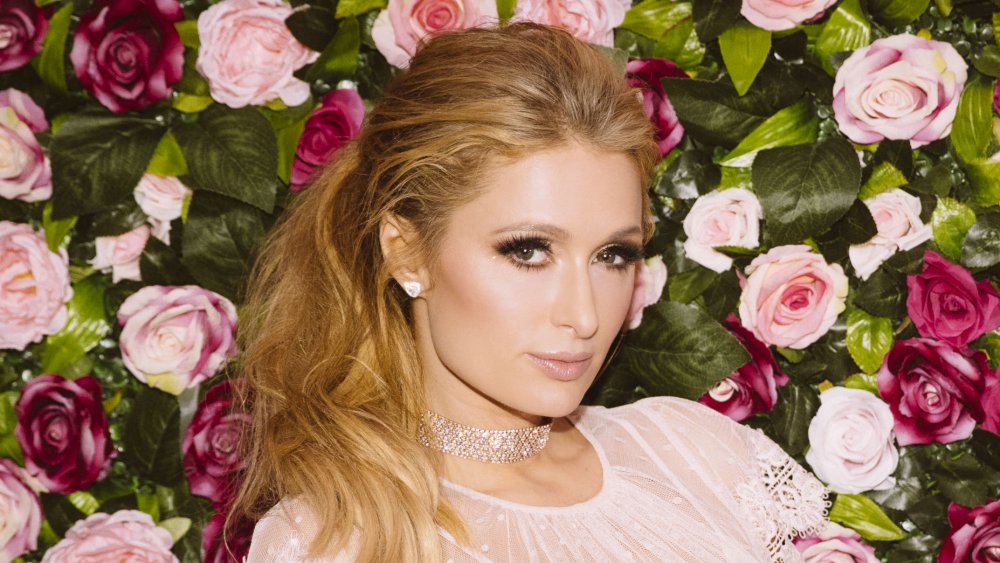 Paris Hilton in front of rose wall