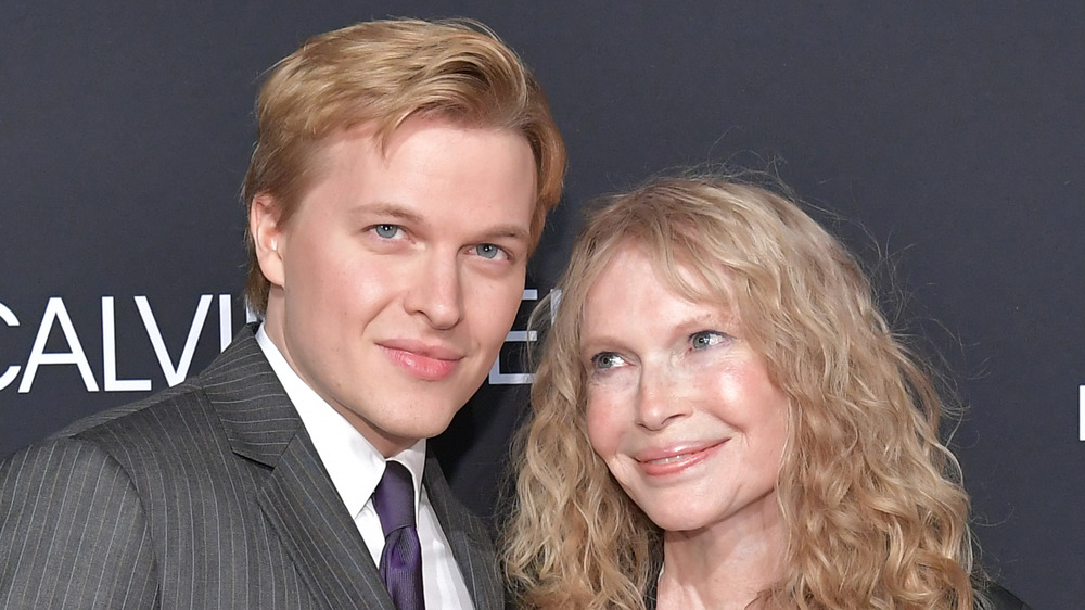 Ronan Farrow posing with mom Mia Farrow