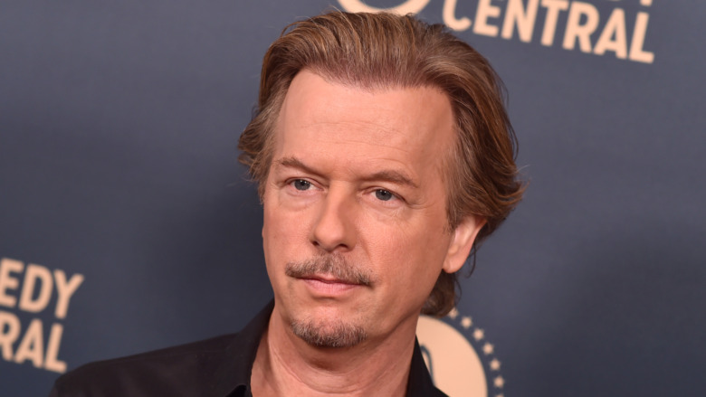 David Spade with a serious expression