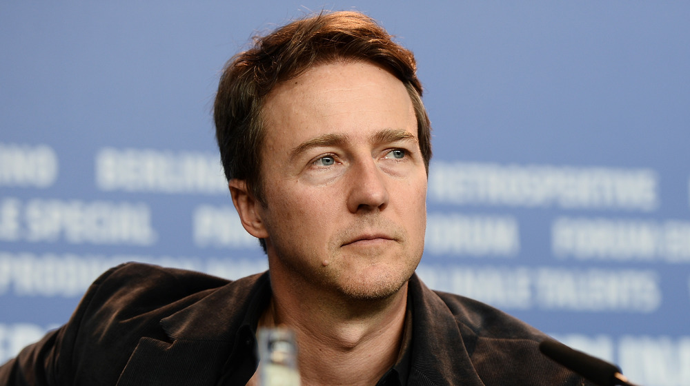 Edward Norton sitting at a panel