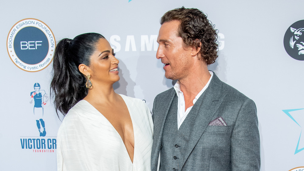 Matthew McConaughey looking at Camila Alves 