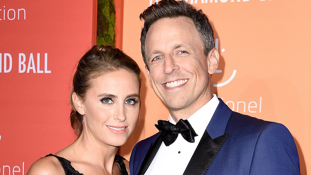 Seth Meyers posing with wife Alexi Ashe 