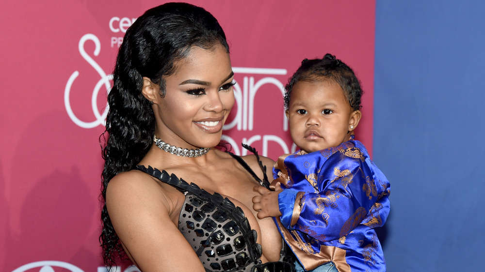 Teyana Taylor holding daughter Iman Tayla Shumpert Jr. 