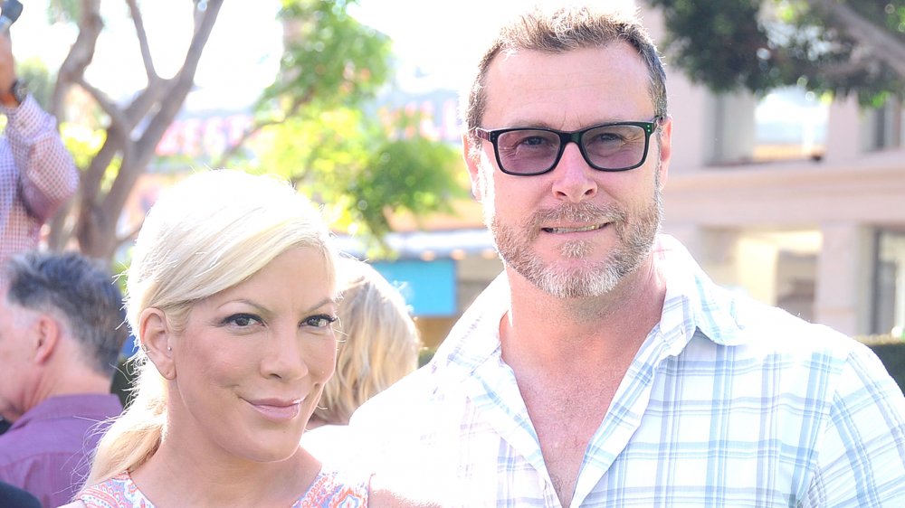 Tori Spelling in a patterned tank top, Dean McDermott in a blue-and-white plaid shirt