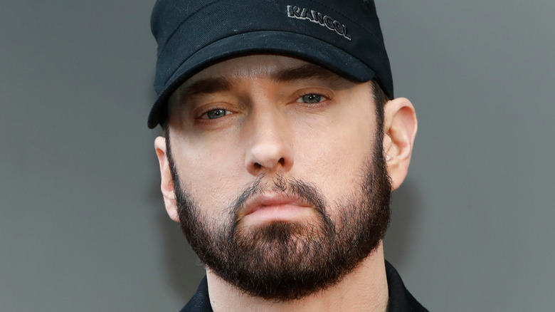 Eminem wearing a black cap