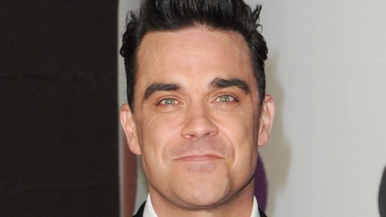 Robbie Williams smirking 