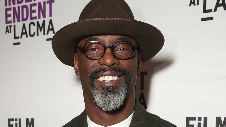 Isaiah Washington posing in brown fedora 