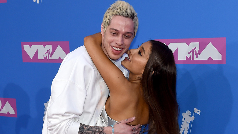 Pete Davidson holding Ariana Grande