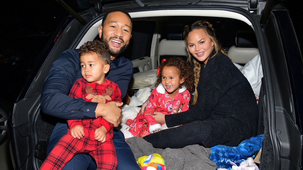 Chrissy Teigen, John Legend, and their children in a car