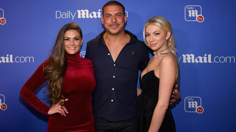 Brittany Cartwright posing with Jax Taylor and Stassi Schroeder