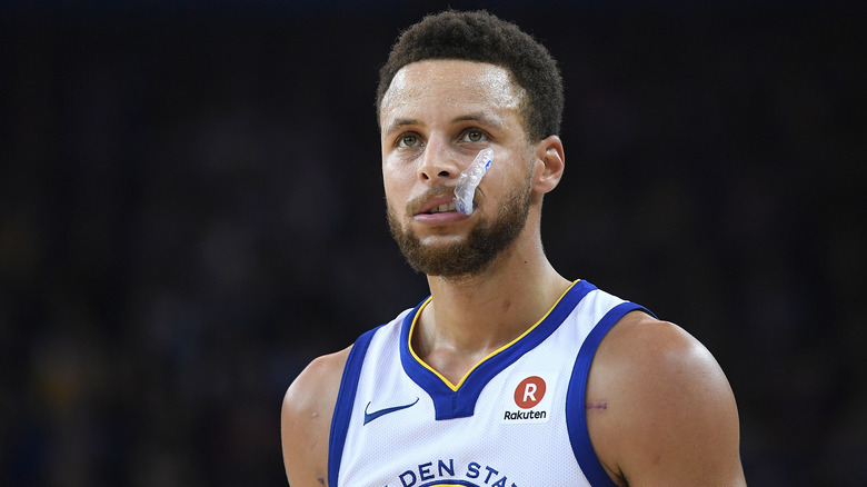 Steph Curry chews on a mouthguard during an NBA game