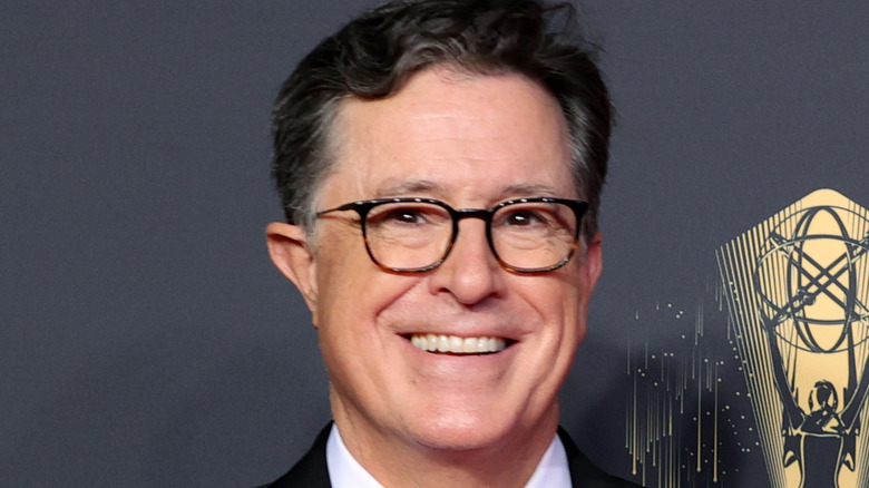 Stephen Colbert smiling on the red carpet