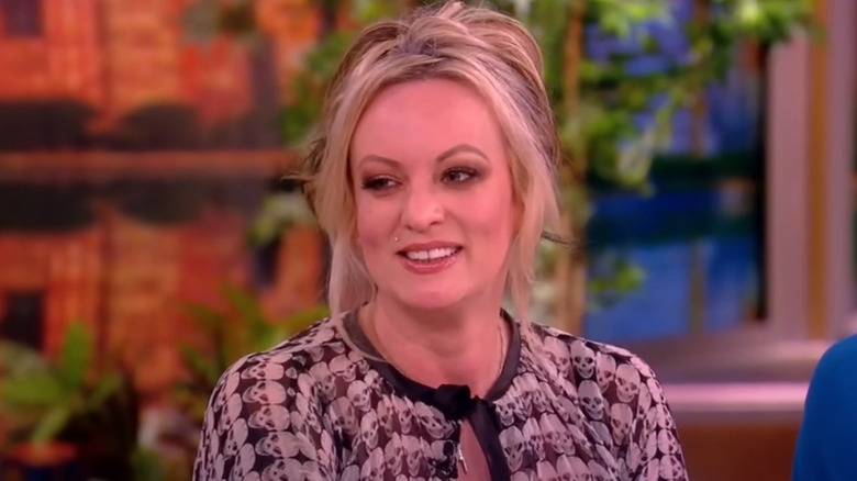 Stormy Daniels smiling and talking