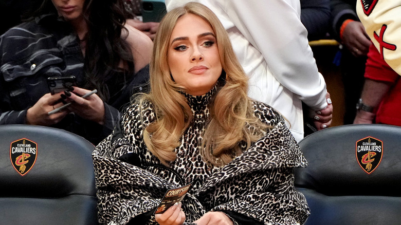 Adele sitting courtside