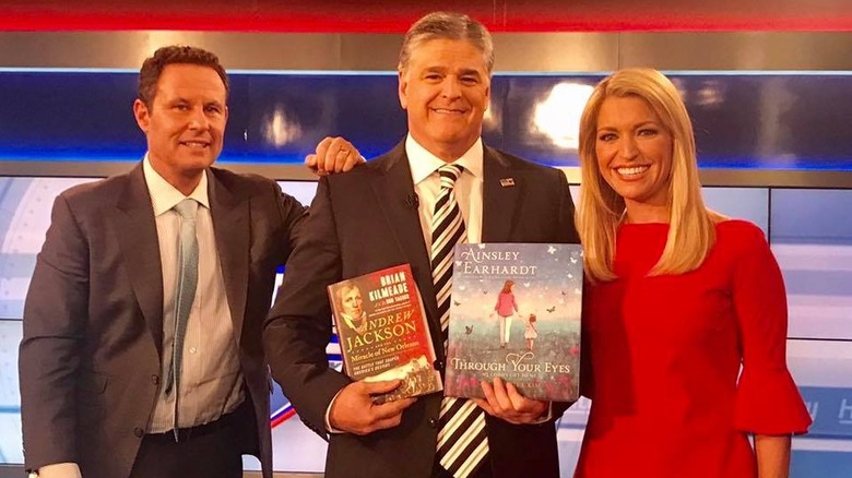 Earhardt poses with Hannity and Kilmeade