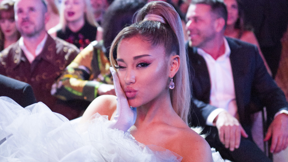Ariana Grande blowing a kiss and winking 