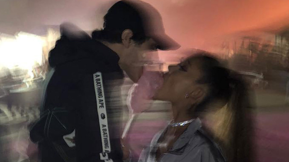 Pete Davidson and Ariana Grande sharing a cotton candy 