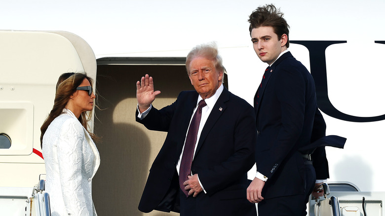 Melania, Donald, and Barron Trump board a U.S. Air Force aircraft