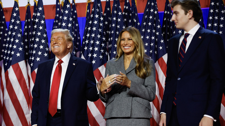 Barron Trump smiles next to his parents on election night