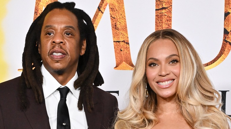 Jay-Z in black tie with Beyonce on red carpet