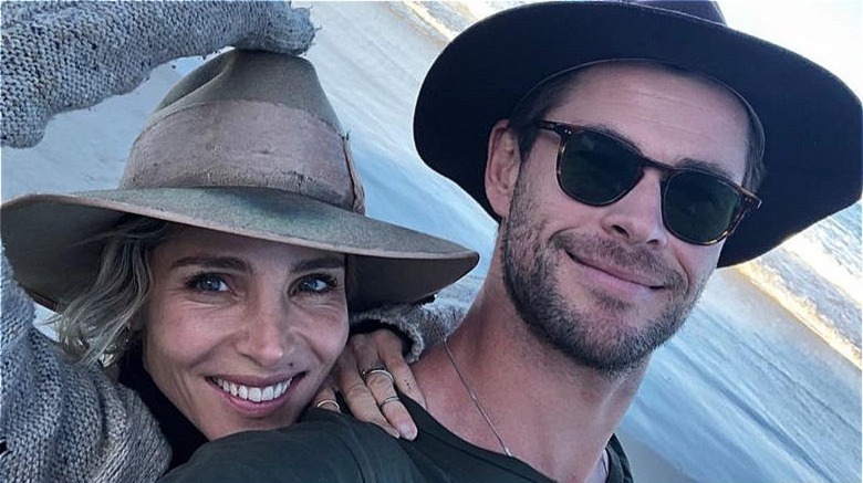 Elsa Pataky and Chris Hemsworth smiling by the sea