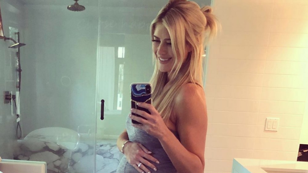 Christina Anstead posing for a selfie while touching her pregnant belly