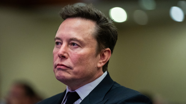 Elon Musk listening as U.S. President-elect Donald Trump speaks during a House Republicans Conference meeting