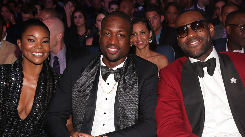 Dwyane Wade, Gabrielle Union, and LeBron James sit together